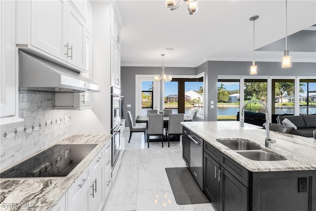 kitchen featuring white cabinetry, hanging light fixtures, stainless steel dishwasher, and a kitchen island with sink