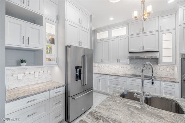 kitchen featuring white cabinetry, sink, tasteful backsplash, decorative light fixtures, and high end fridge