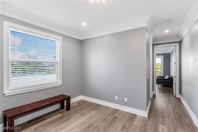 spare room with a baseboard heating unit, ornamental molding, and light hardwood / wood-style flooring