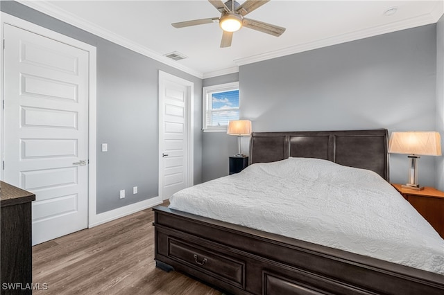 bedroom with hardwood / wood-style flooring, ceiling fan, and ornamental molding