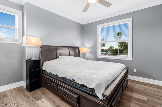 bedroom with ceiling fan, ornamental molding, and hardwood / wood-style flooring