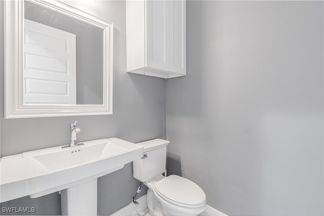 bathroom featuring toilet and sink