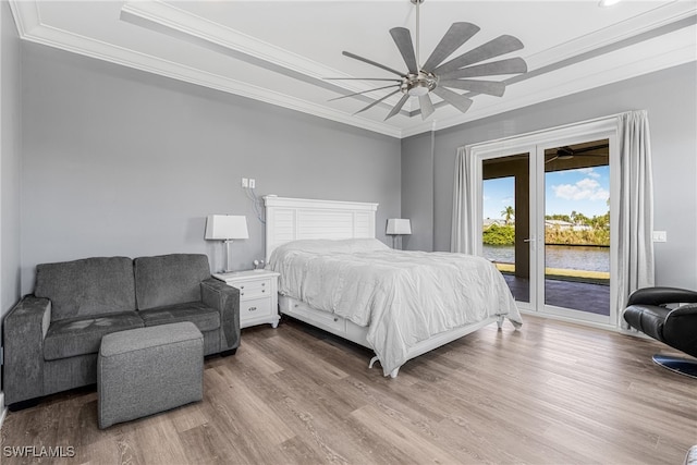 bedroom featuring hardwood / wood-style floors, ceiling fan, ornamental molding, and access to outside