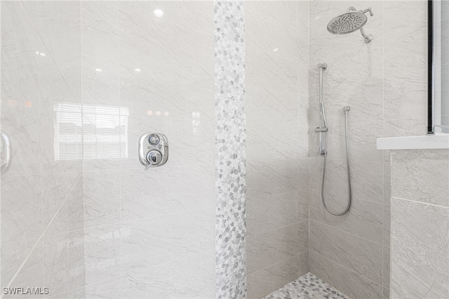 bathroom with a tile shower