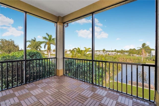 unfurnished sunroom with a water view