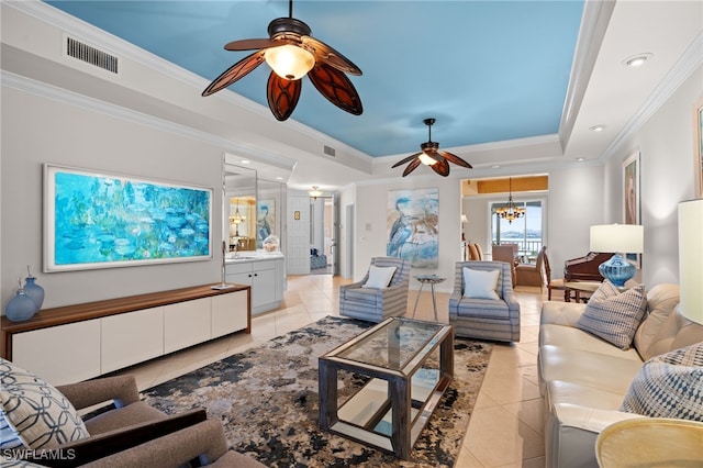 living room featuring a tray ceiling, light tile patterned flooring, a chandelier, and ornamental molding