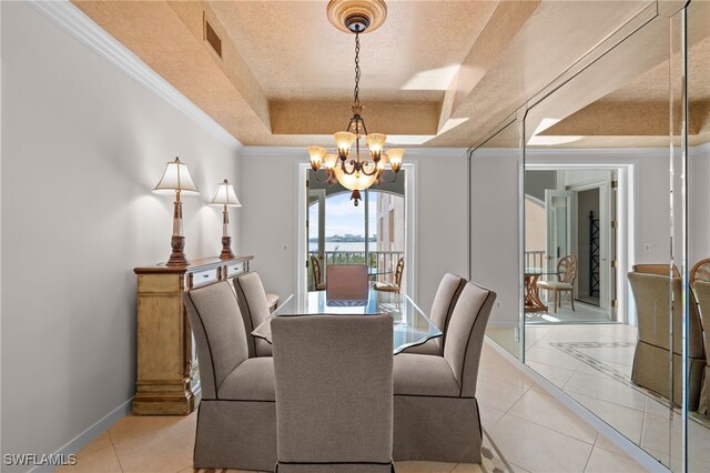 2000 Royal Marco Way Unit 2-407, Marco Island, FL 34145 - dining space with a chandelier, a tray ceiling, light tile patterned floors, baseboards, and ornamental molding