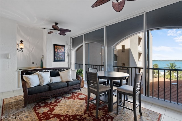 2000 Royal Marco Way Unit 2-407, Marco Island, FL 34145 - tiled living room featuring ceiling fan, a water view, arched walkways, and expansive windows