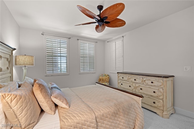 bedroom featuring ceiling fan and light carpet