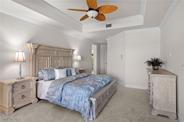 carpeted bedroom with a raised ceiling, ceiling fan, and crown molding