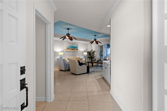 hallway with ornamental molding and light tile patterned floors