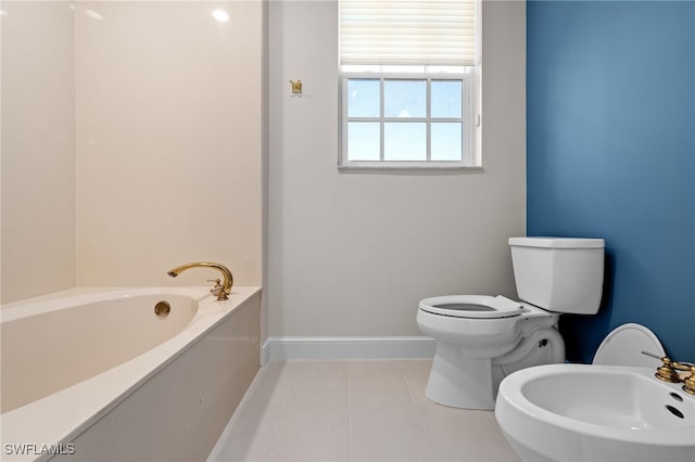 bathroom with tile patterned floors, toilet, a bathing tub, and a bidet