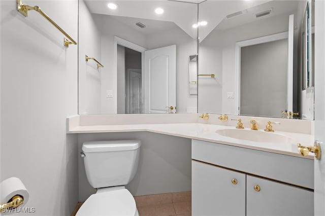 bathroom featuring tile patterned flooring, vanity, and toilet