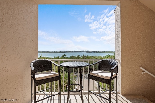 balcony featuring a water view