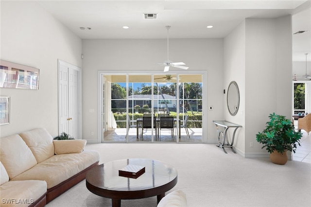 living room featuring carpet and ceiling fan