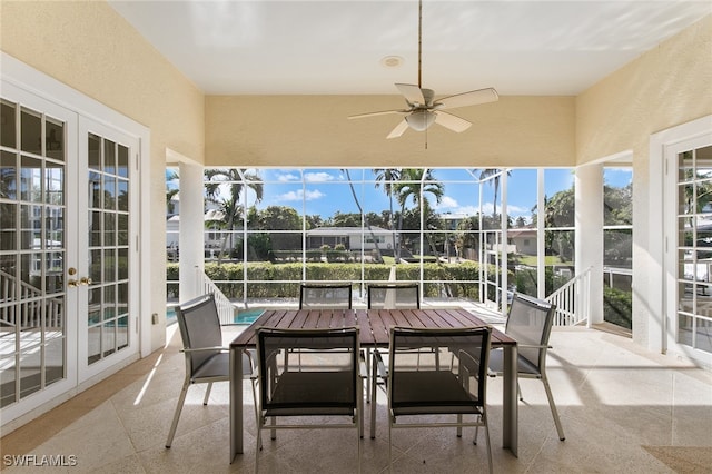 sunroom featuring ceiling fan and french doors