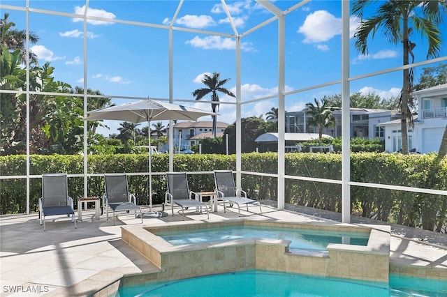 view of pool featuring a lanai, a patio area, and an in ground hot tub