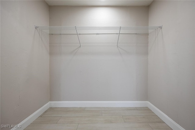 spacious closet featuring light hardwood / wood-style floors