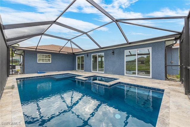 view of pool with a patio area, a lanai, and an in ground hot tub