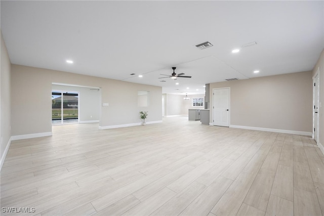 unfurnished living room featuring light hardwood / wood-style flooring and ceiling fan