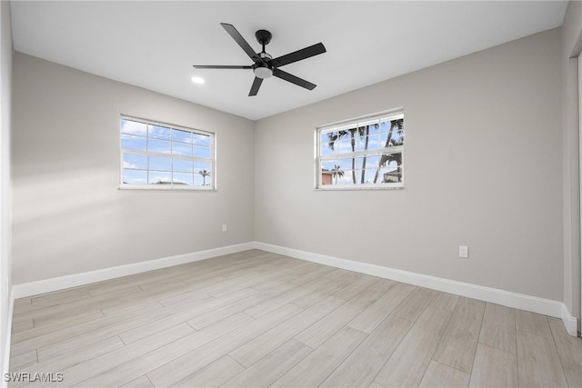 empty room with light hardwood / wood-style flooring and ceiling fan