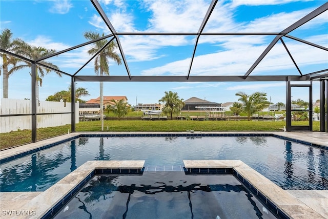 view of pool with a lawn and glass enclosure