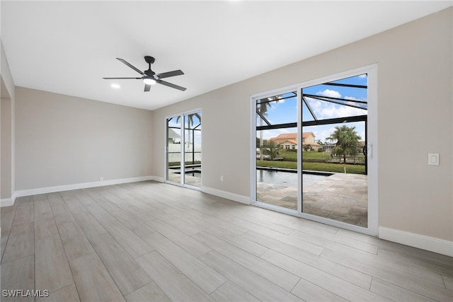 empty room featuring ceiling fan and light hardwood / wood-style flooring