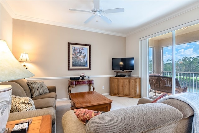 living room featuring carpet, ceiling fan, and ornamental molding