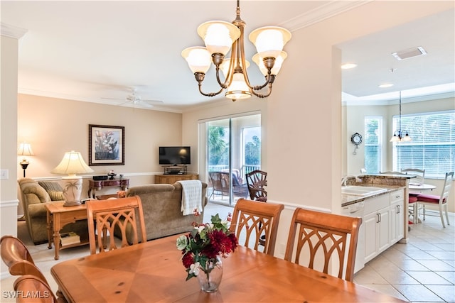 tiled dining area with ceiling fan with notable chandelier, ornamental molding, and sink