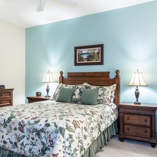 bedroom featuring light carpet and ceiling fan