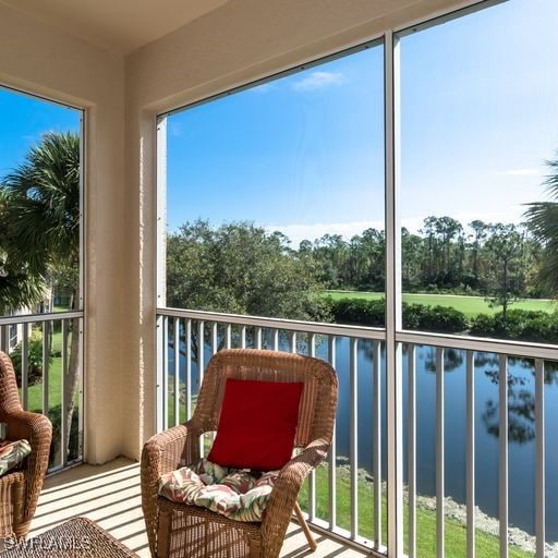 sunroom / solarium with a water view