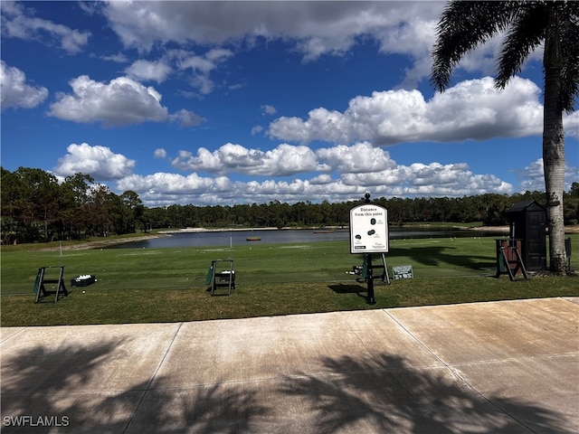 view of home's community featuring a lawn and a water view