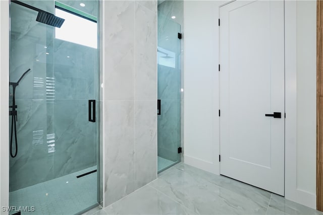 bathroom with a shower with door