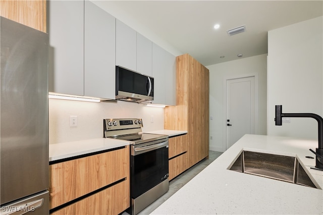 kitchen featuring white cabinets, sink, and stainless steel appliances