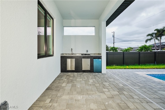 view of patio / terrace with area for grilling and sink