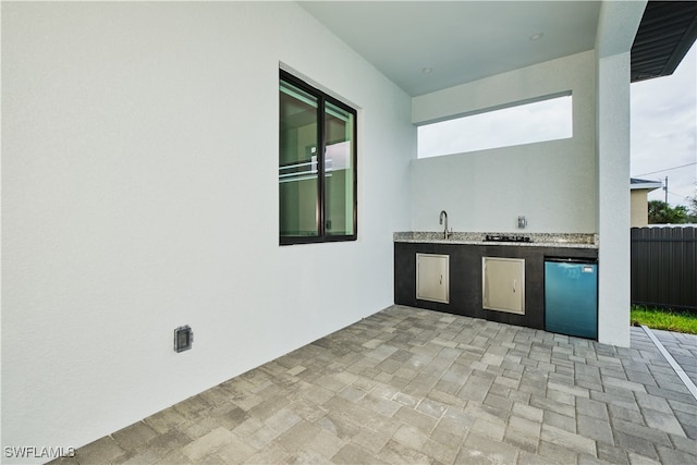 view of patio / terrace with an outdoor kitchen and sink