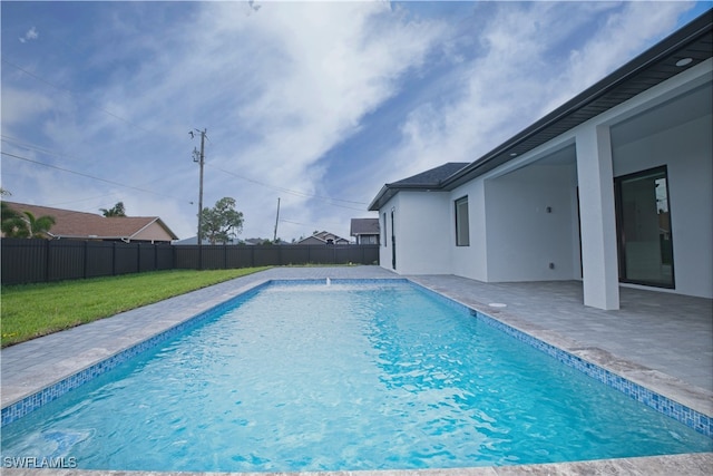 view of swimming pool featuring a lawn and a patio area