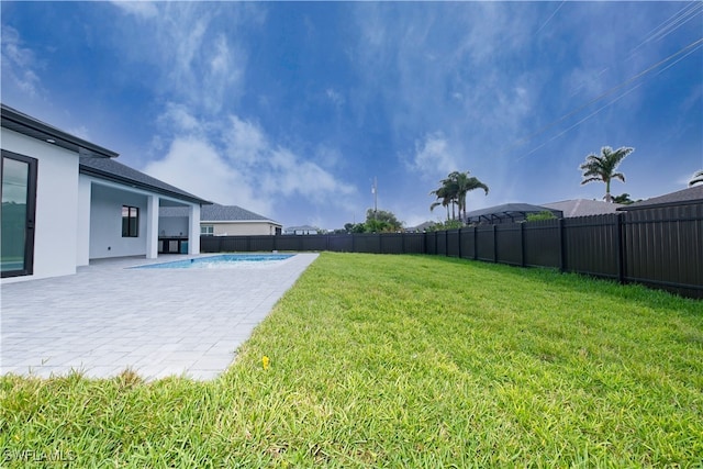 view of yard with a fenced in pool and a patio area