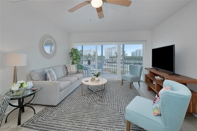 living room featuring ceiling fan and light hardwood / wood-style flooring