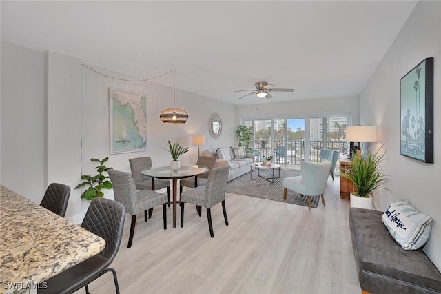 1 Bluebill Ave Unit 401, Naples, FL 34108 - living room with light wood-type flooring and a ceiling fan