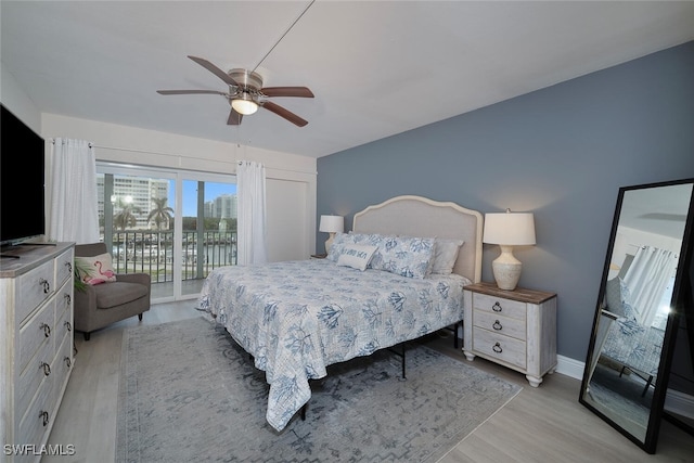 bedroom featuring access to outside, light hardwood / wood-style flooring, and ceiling fan