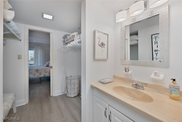 1 Bluebill Ave Unit 401, Naples, FL 34108 - ensuite bathroom featuring vanity, baseboards, ensuite bathroom, and wood finished floors