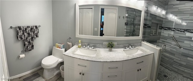 bathroom with a shower with door, vanity, hardwood / wood-style floors, and toilet