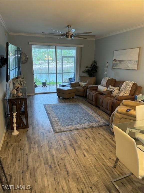 living room with ceiling fan, wood-type flooring, and ornamental molding