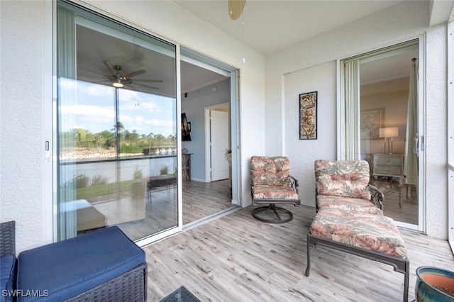 sunroom / solarium featuring ceiling fan