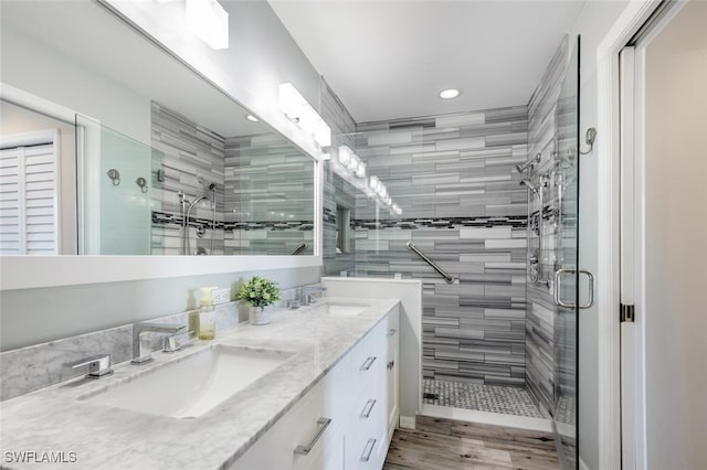 bathroom with vanity, wood-type flooring, and a shower with shower door