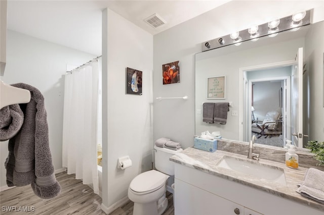 full bathroom featuring shower / tub combo with curtain, vanity, wood-type flooring, and toilet