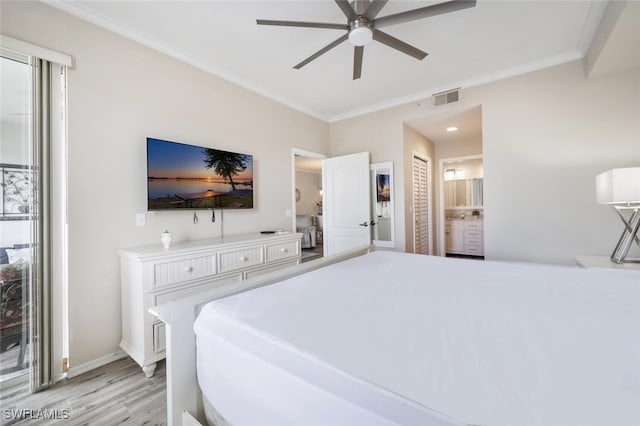 bedroom featuring connected bathroom, light hardwood / wood-style floors, ceiling fan, and crown molding