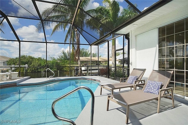 view of pool with a lanai and a patio area