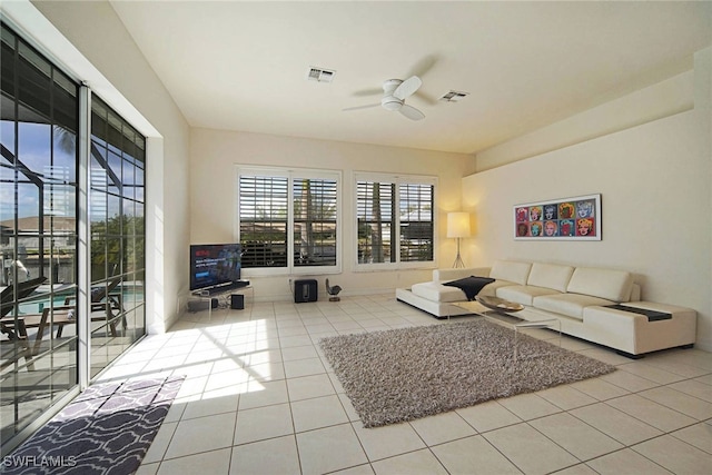 tiled living room with ceiling fan